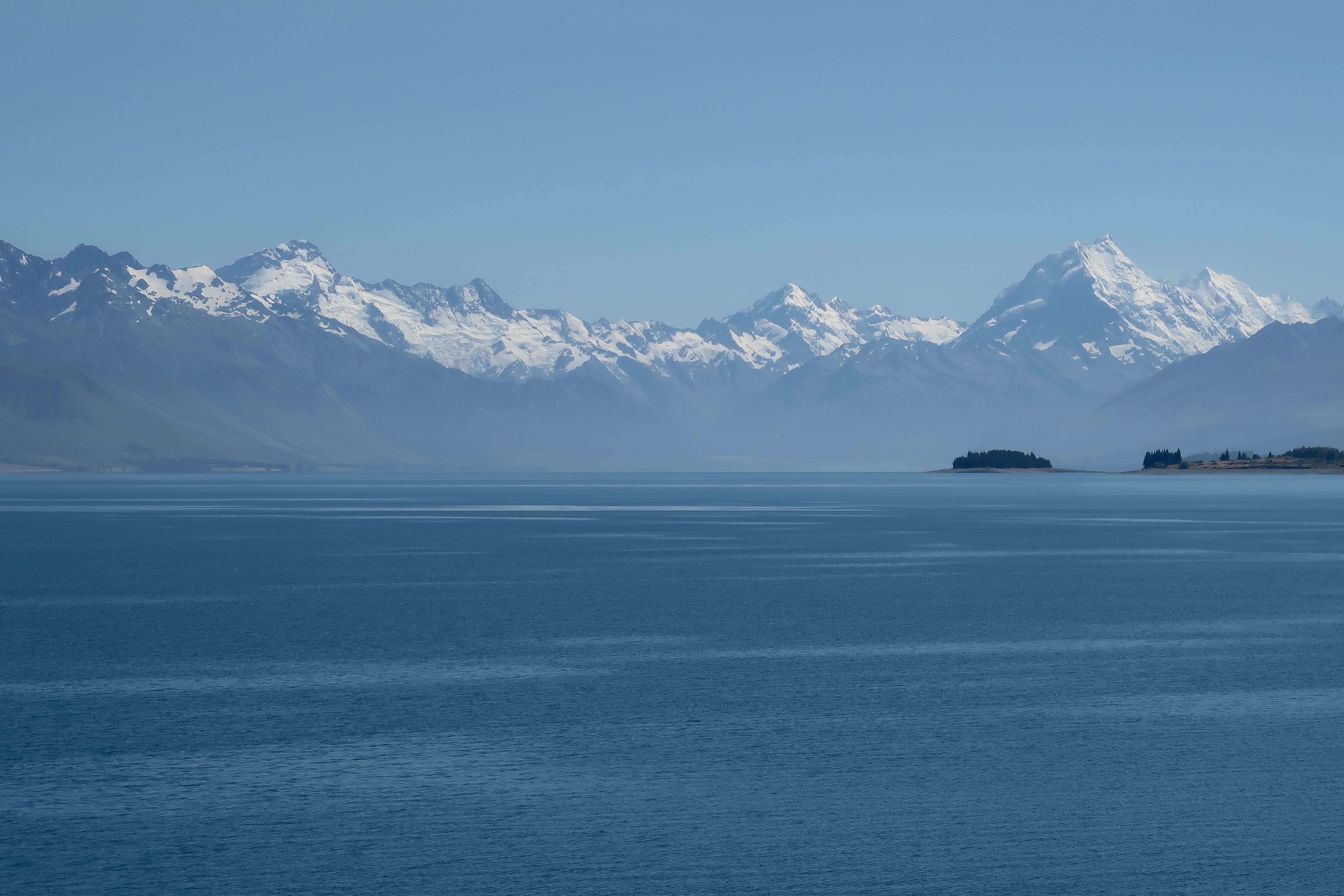 Snow-capped mountains above a still lake, Patagonia, upcoming WildInvest expedition 2026/2027