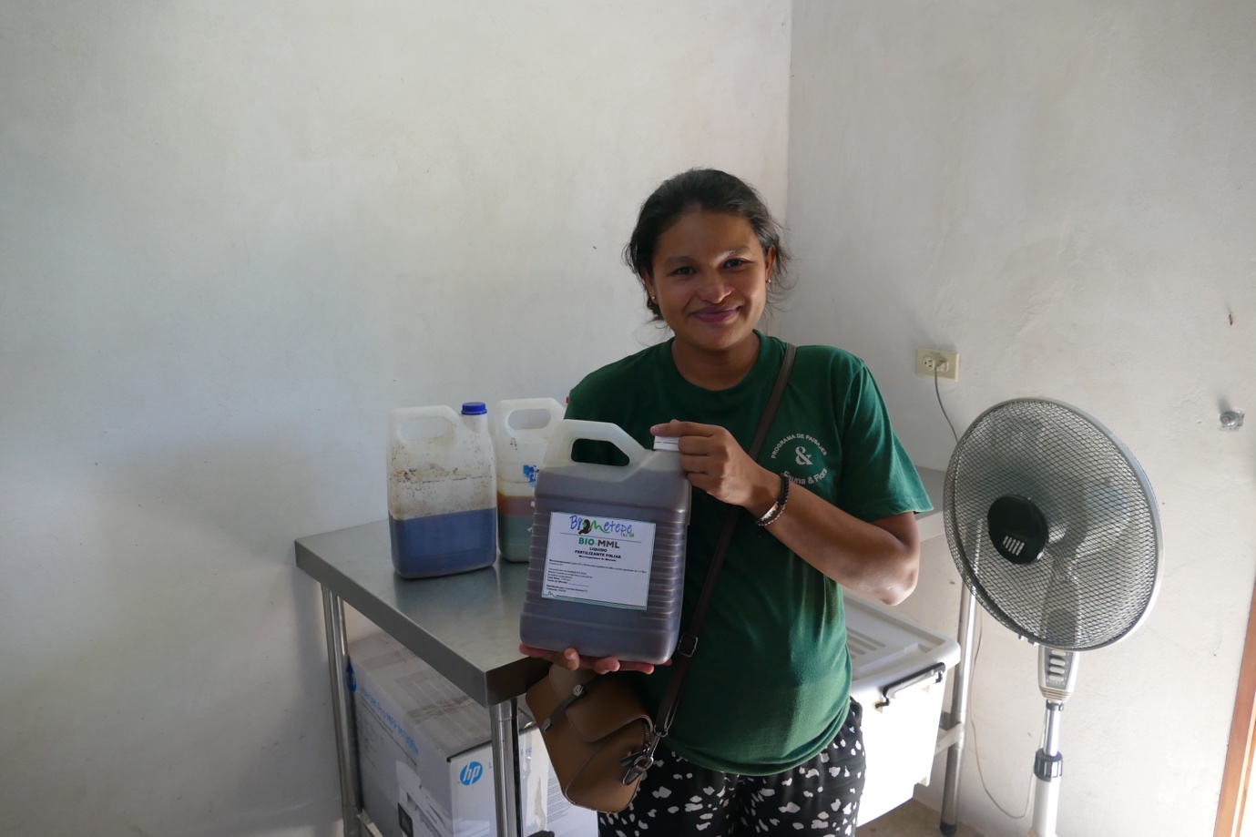 Selena Hernandez, Biometepe's Agroecology Technical Specialist, holding the organic bio-fertilisers Biometepe produce